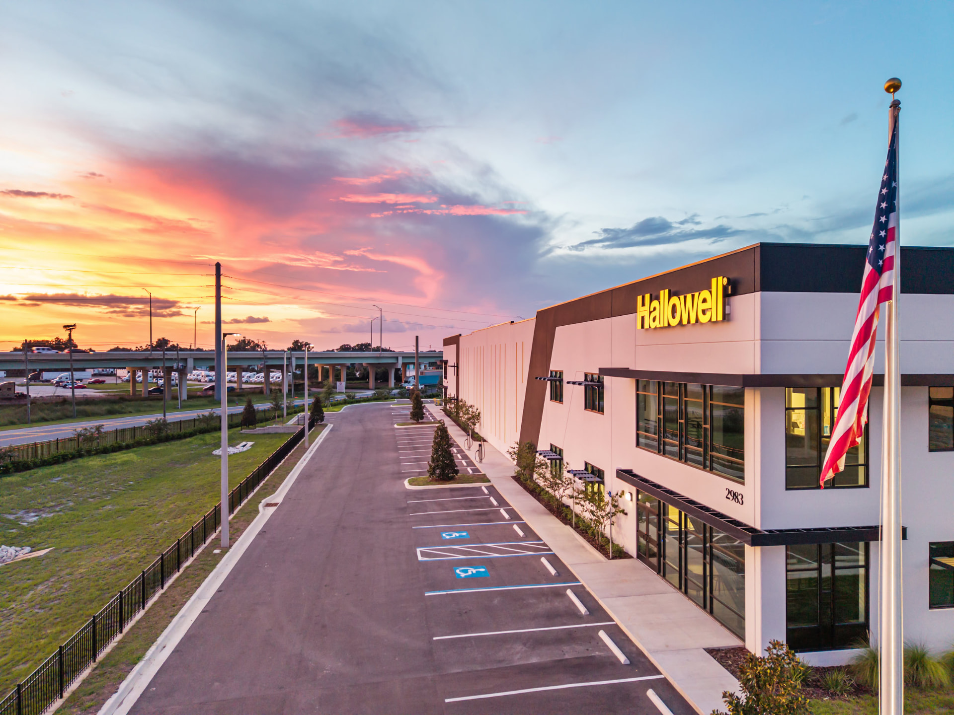 Hallowell facility facade at dusk with illuminated signage, aerial photography by IRL Marketing