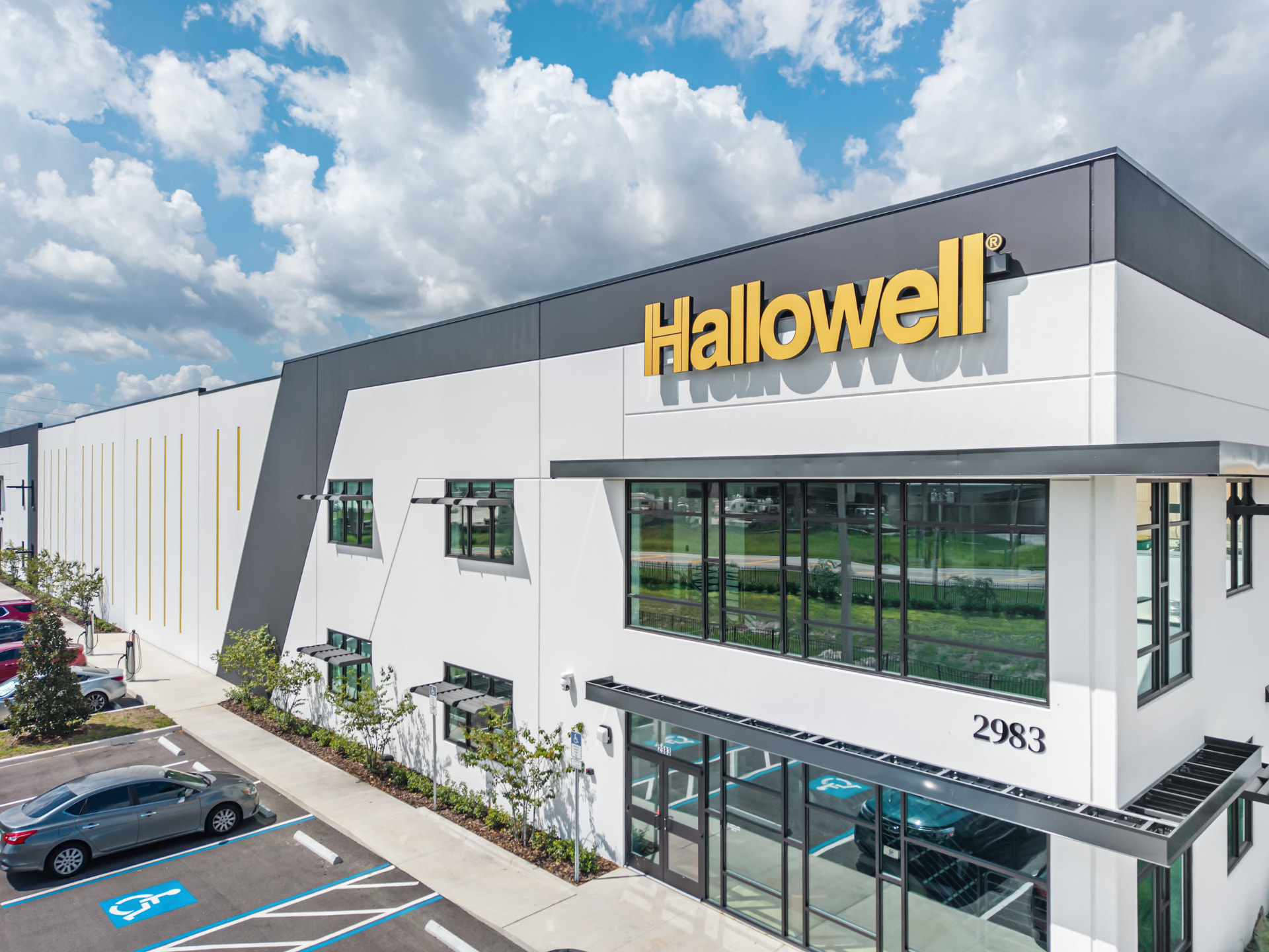 Hallowell facility facade and illuminated signage, daytime aerial photography by IRL Marketing