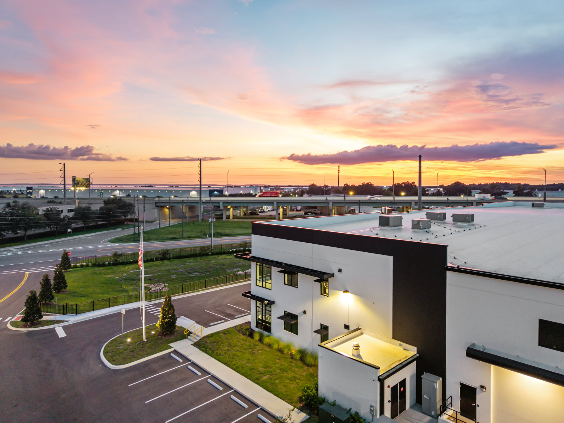 Hallowell facility facade at dusk with illuminated signage, aerial photography by IRL Marketing