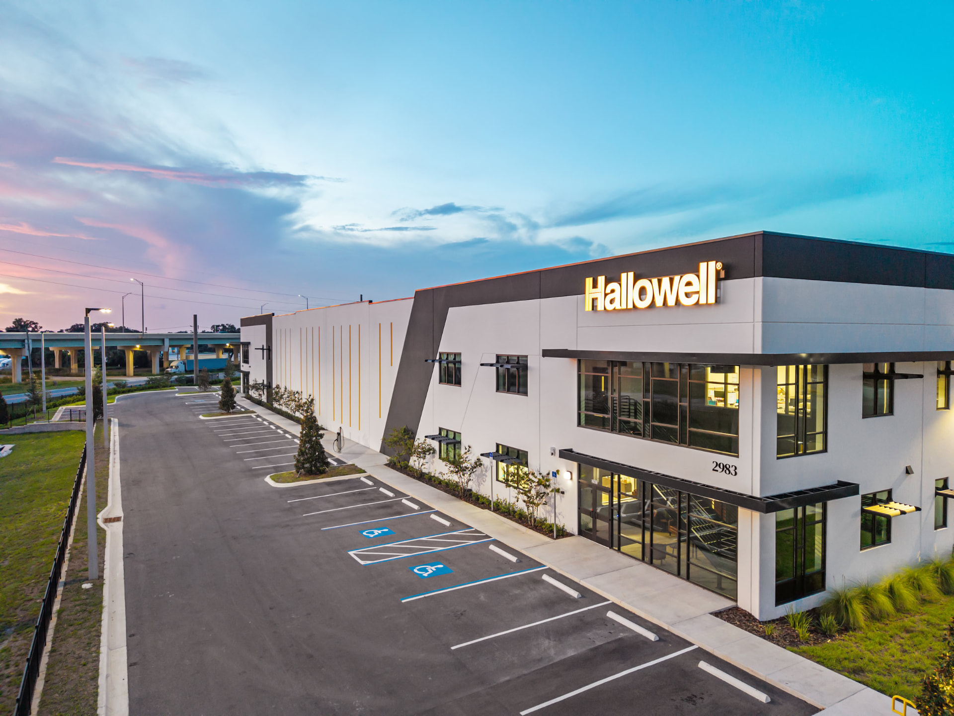 Hallowell facility facade at dusk with illuminated signage, aerial photography by IRL Marketing
